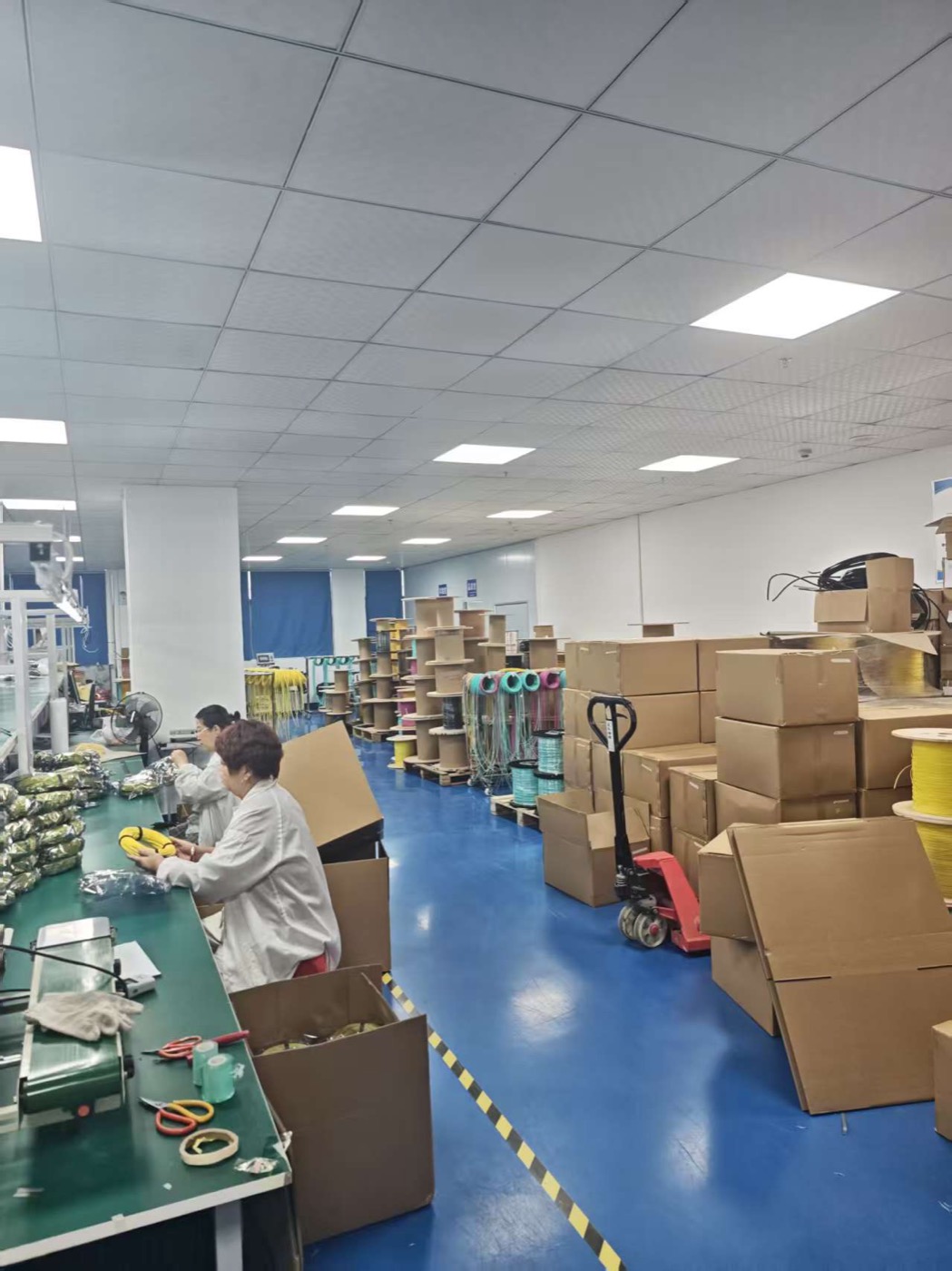 fiber optic packing area with cartons and cable spools